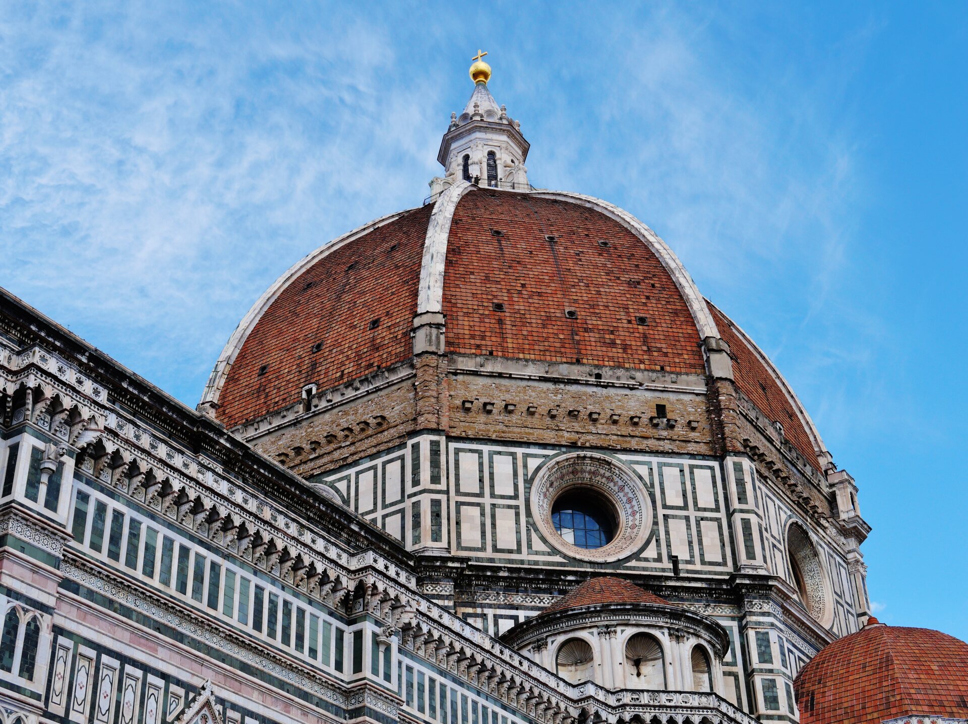 Brunelleschi's Dome rising above the marble façade of Florence Cathedral in Florence.