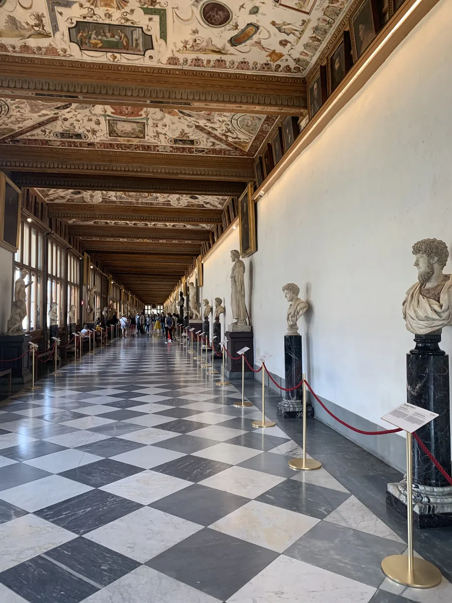 Sculptures and decorated ceilings in a corridor of the Uffizi Gallery, Florence