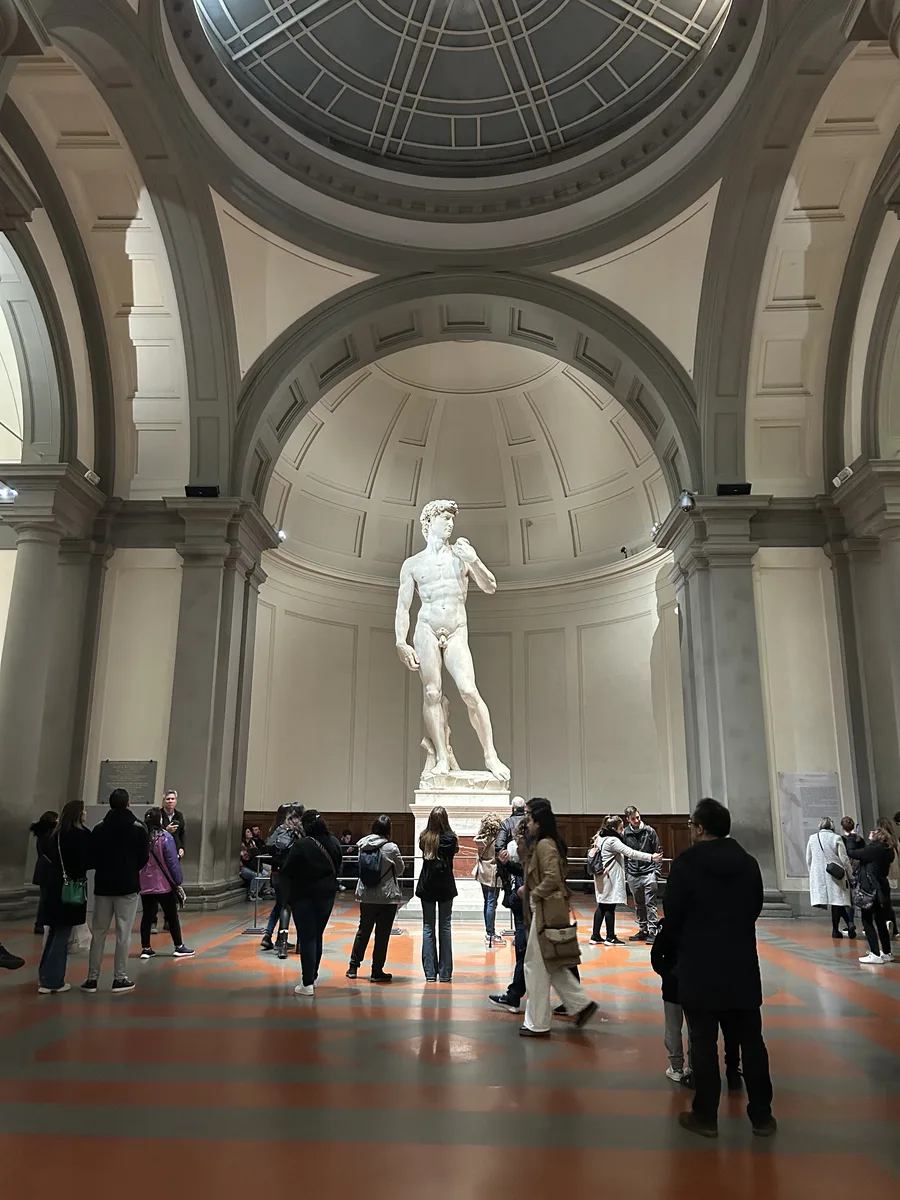Visitors admiring Michelangelo's David at the Galleria dell'Accademia, Florence