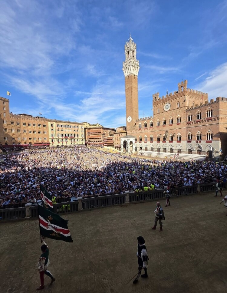 Piazza del Campo and Torre del Mangia filled with spectators during the Palio di Siena
