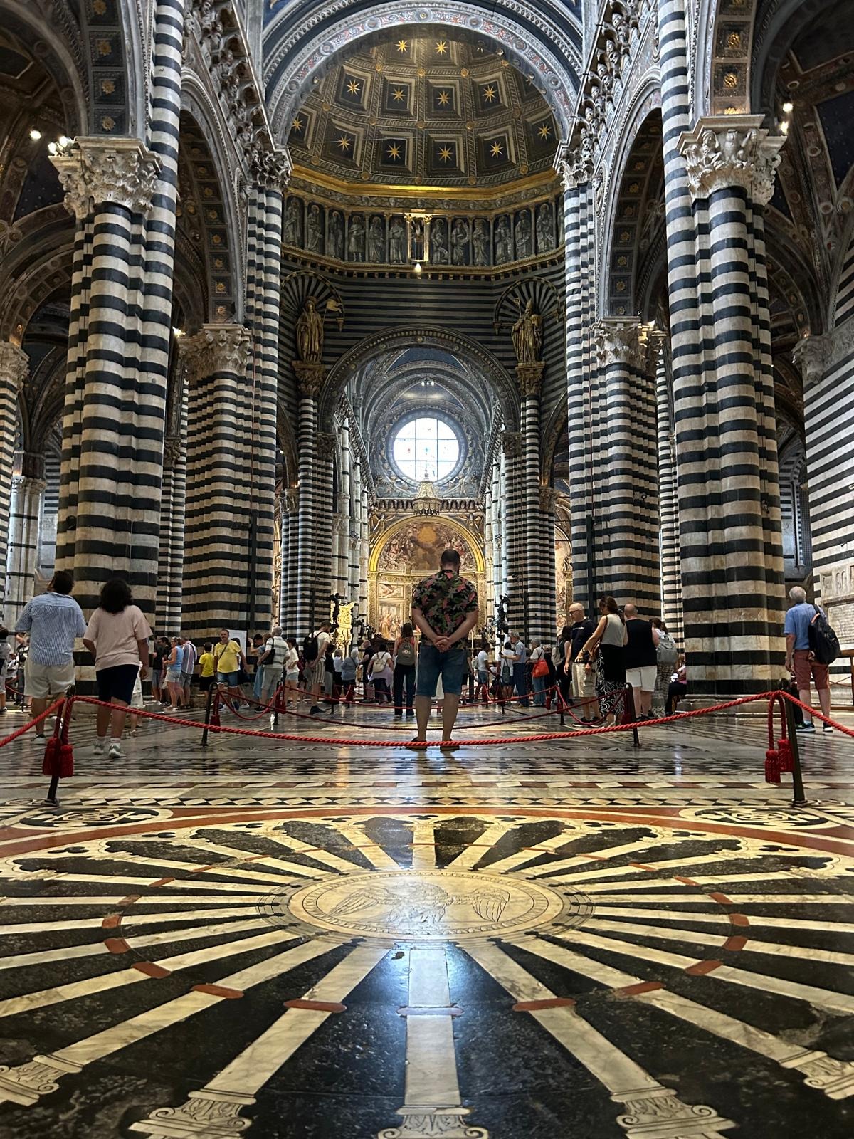 Marble floor and striped columns inside Siena Cathedral in Siena, Italy.